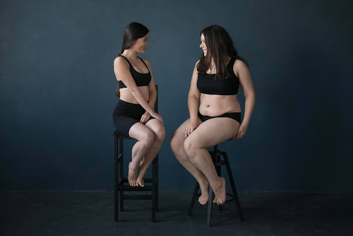 Duas mulheres sentadas em bancos. Aprenda a reconhecer Lipedema com a MyMoment